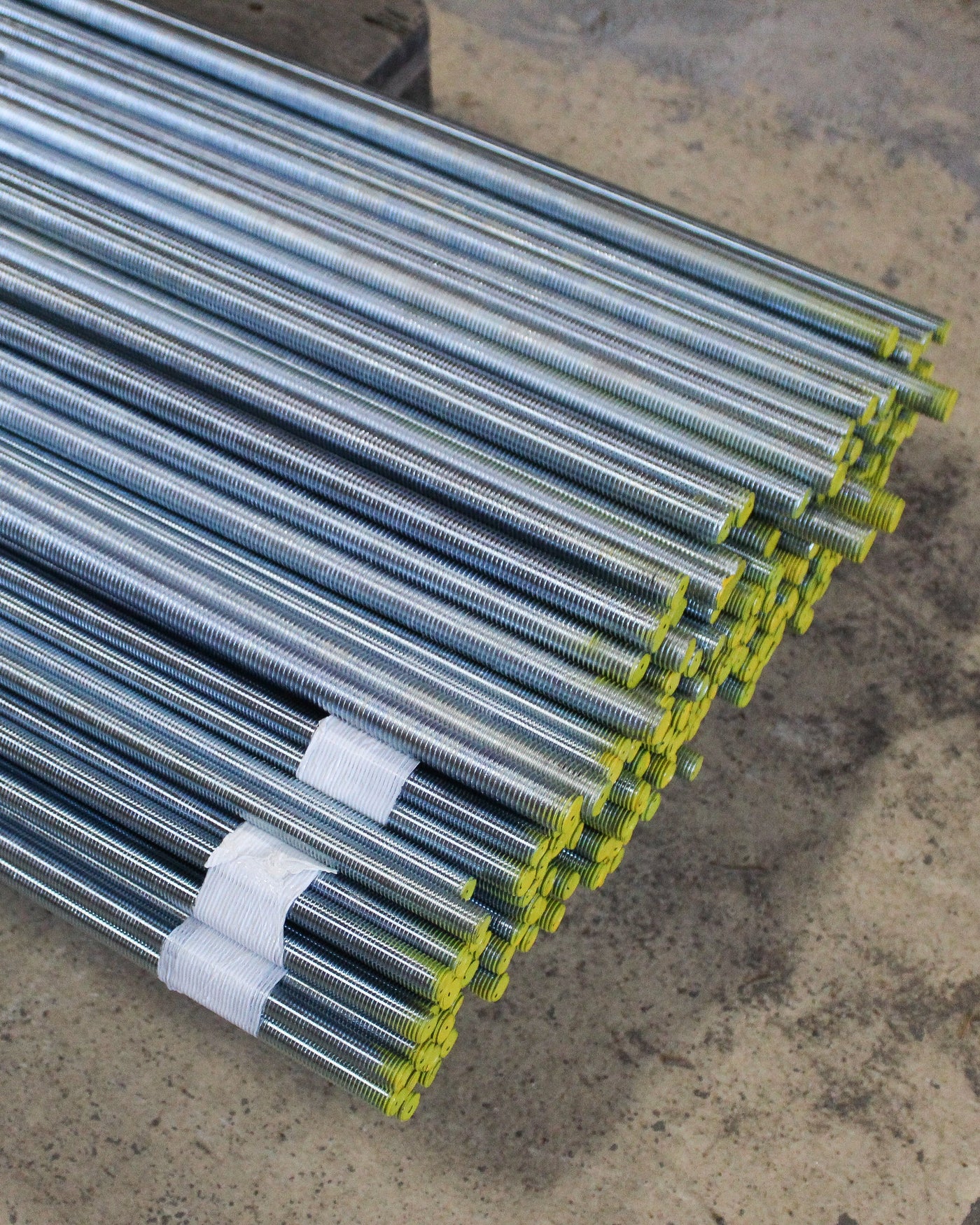 Threaded rods on a pallet ready for shipping.